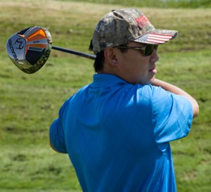 Picture of the sole of the driver over the shoulder of a golfer.